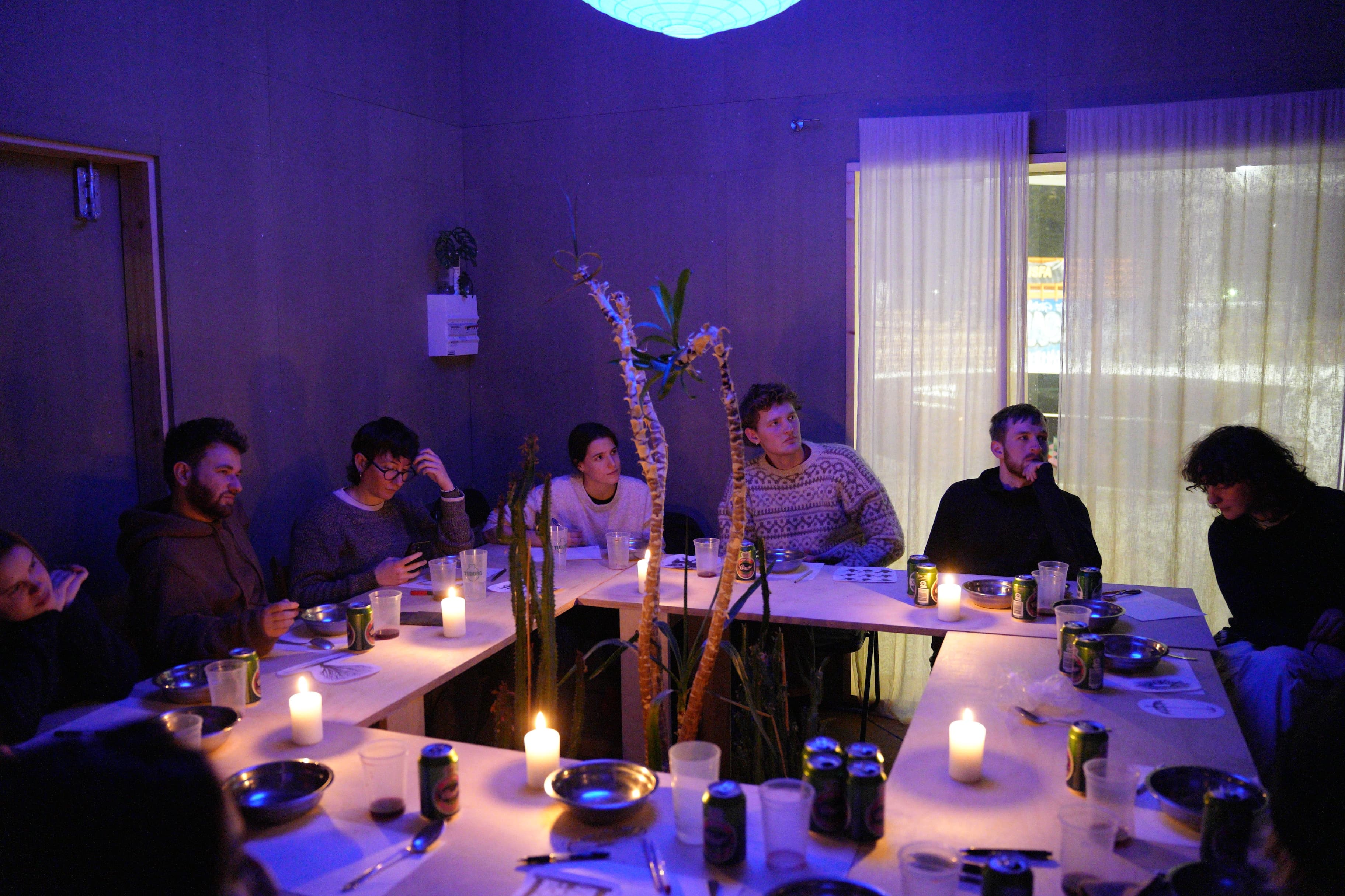 Attendees in the night time with candles lit having a class.