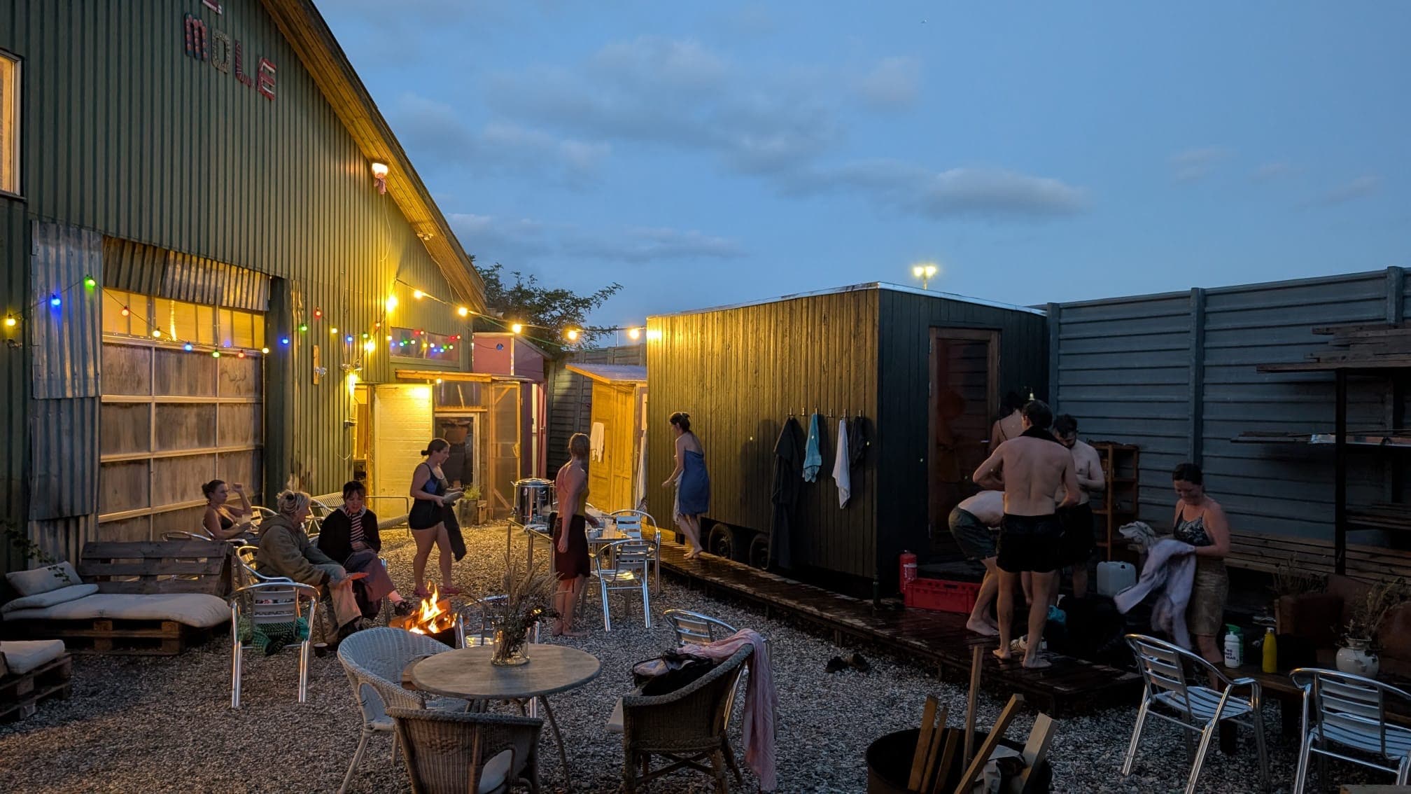 Sauna guests enjoying a drink in the warm summer evening.